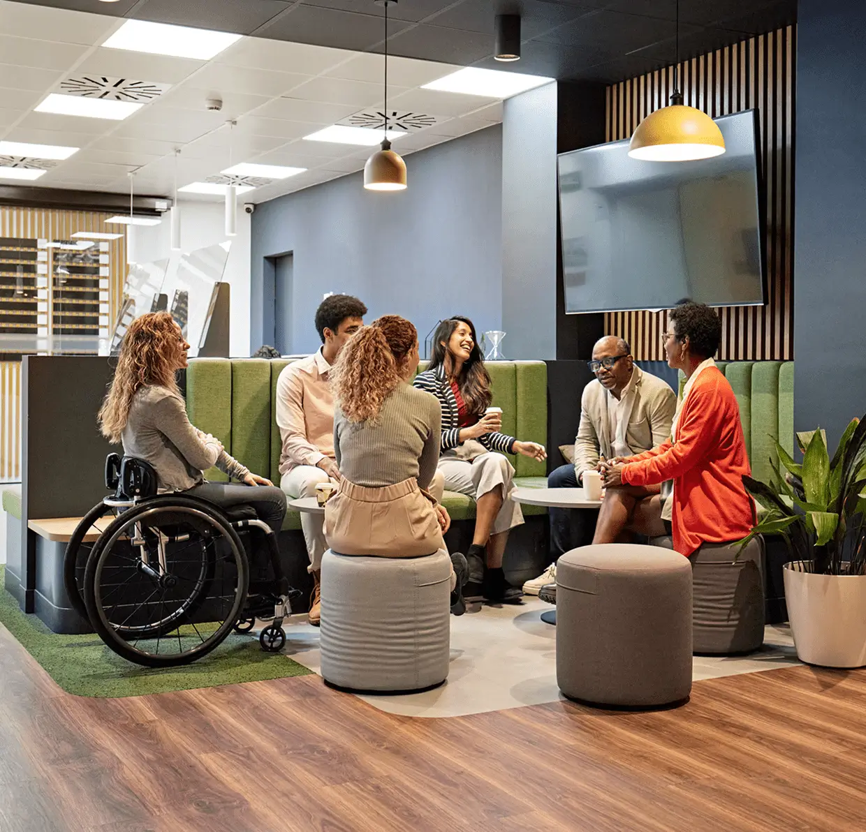Inclusive team meeting in modern office lounge
